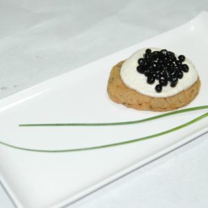 Mini bilini with vegan ricotta and balsamic vinegar caviar.